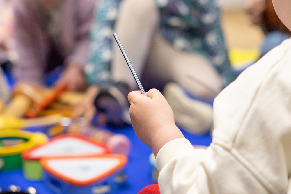 child playing with musical instrument